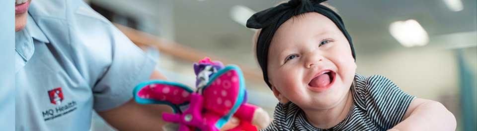 A clinician with a baby girl