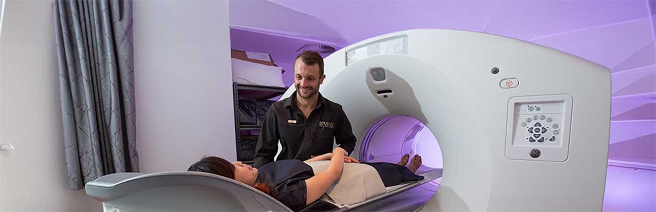 A clinician putting a patient in an MRI