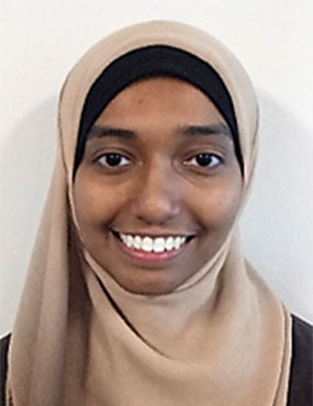 Dr Jisha Kunju, smiling, wearing a brown headscarf.