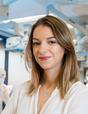 Jordan Griffiths, a second-year Doctor of Medicine student, standing in front of some anatomical models and other medical equipment.