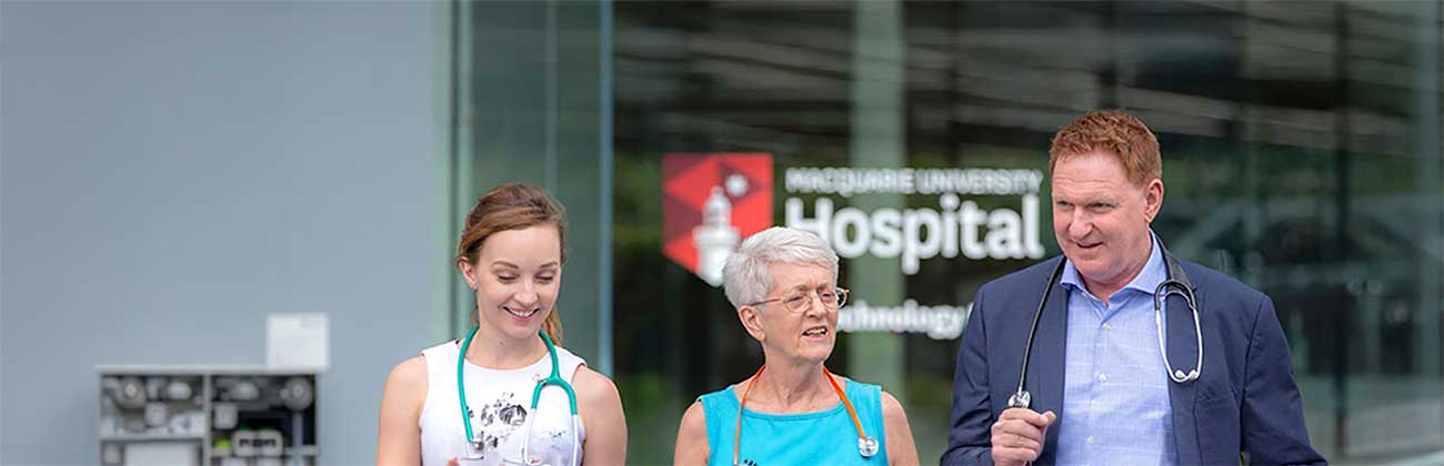 Three healthcare professionals walking outside the hospital