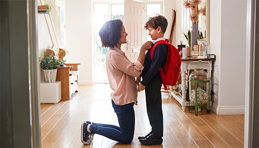 A mother getting her son ready for school