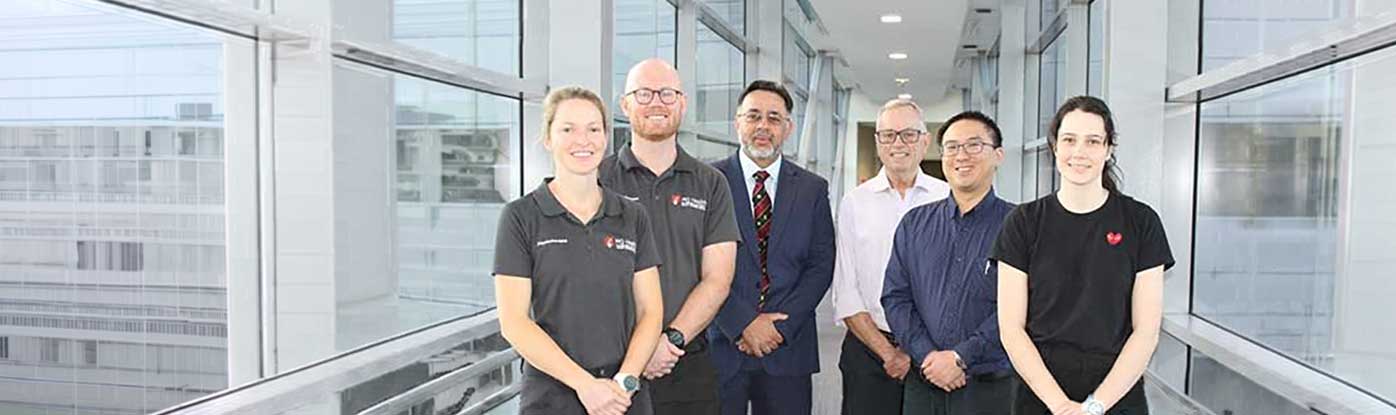 Six of the team members standing in a hospital corridor 