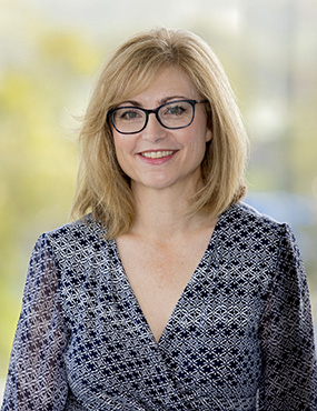 Professor Johanna Westbrook, a Director with the AIHI, smiling, wearing a patterned blouse.