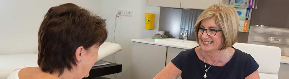 An allied health worker talking to a patient