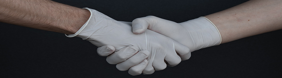 Two gloved hands shaking